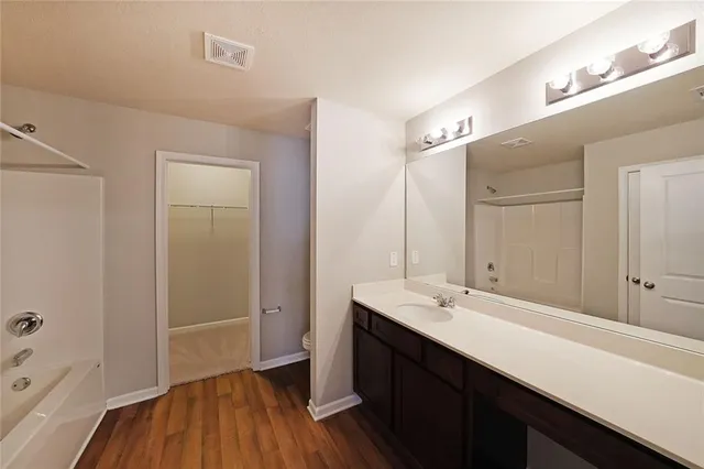 a bathroom with a sink a mirror and a shower