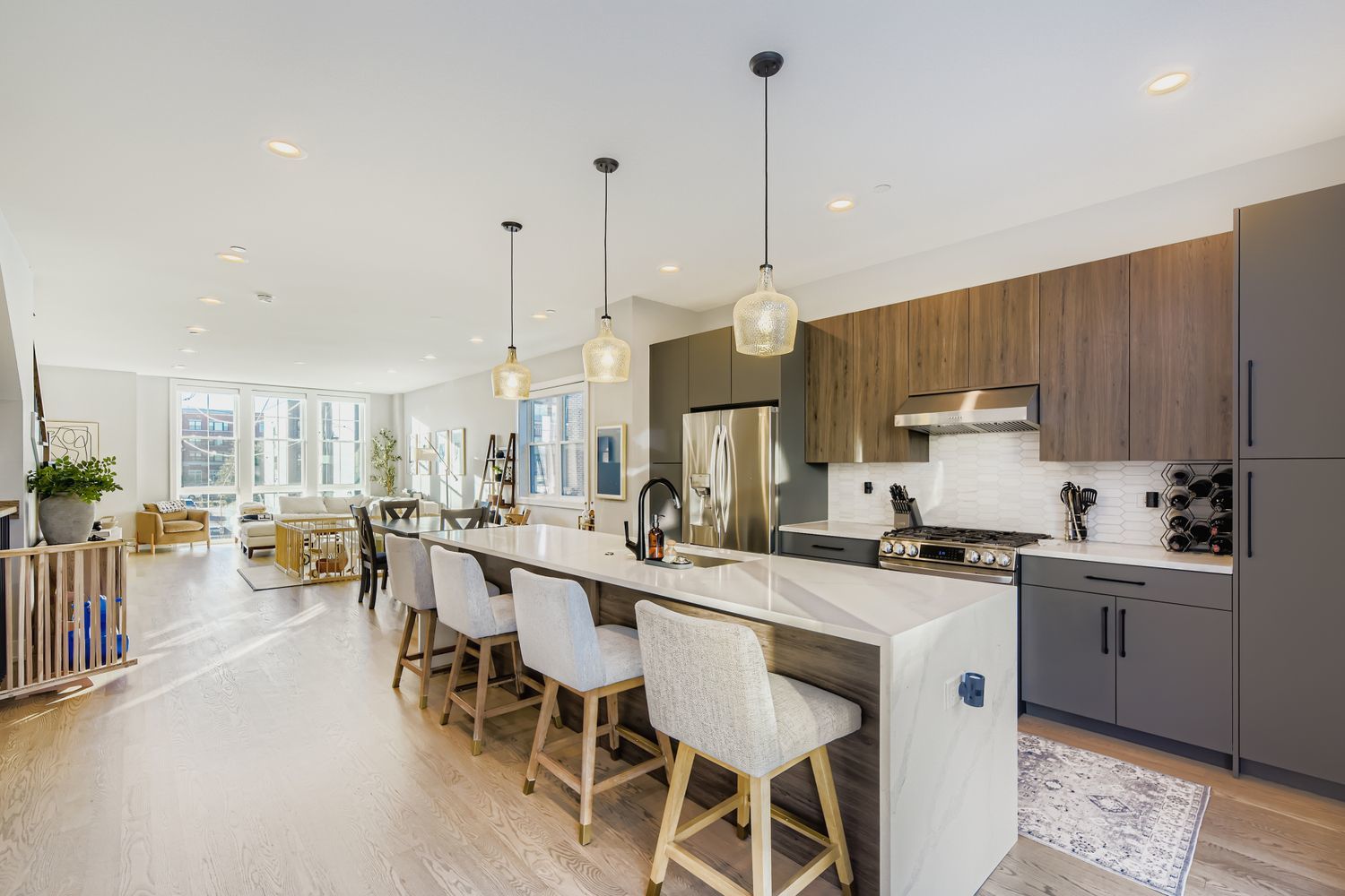 4446 South Drexel Boulevard, Unit B Chicago, IL 60653 - Photo 9 of 16 a kitchen with stainless steel appliances a table chairs sink and cabinets
