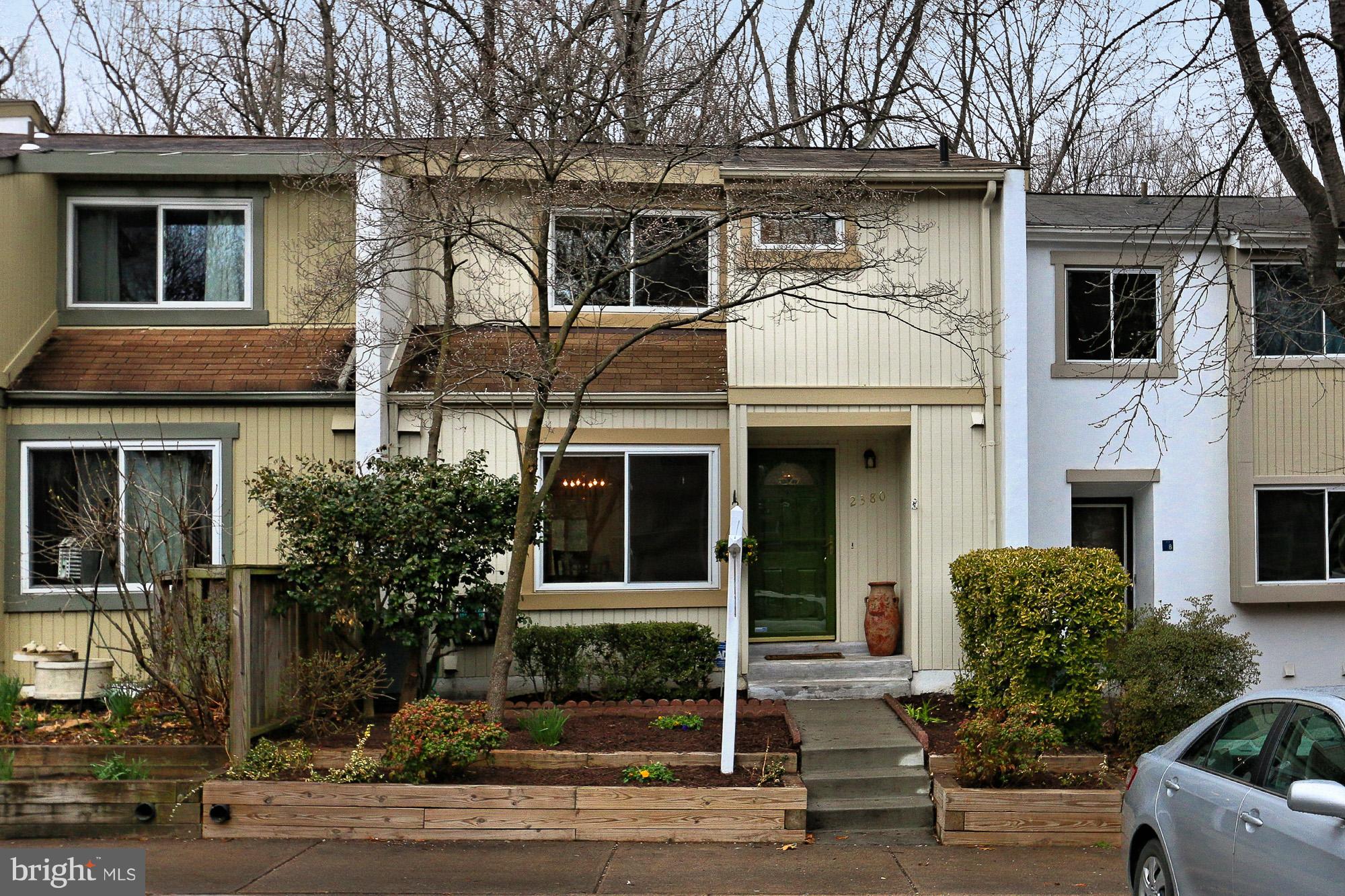 2380 Generation Drive Reston, VA 20191 - Photo 1 of 30 a view of a white house with large windows and a small yard