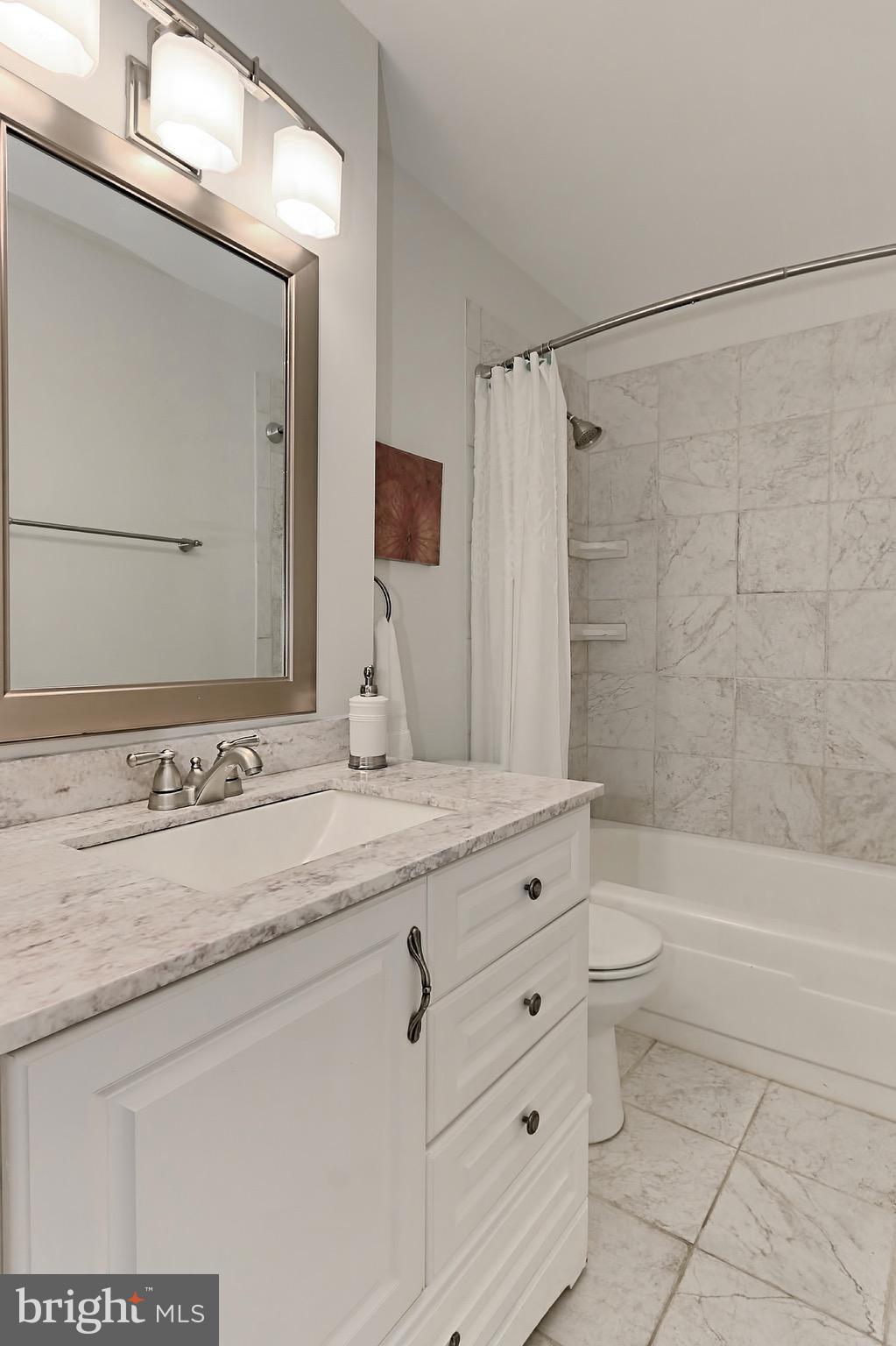 2380 Generation Drive Reston, VA 20191 - Photo 20 of 30 a bathroom with a granite countertop sink a toilet and a bathtub