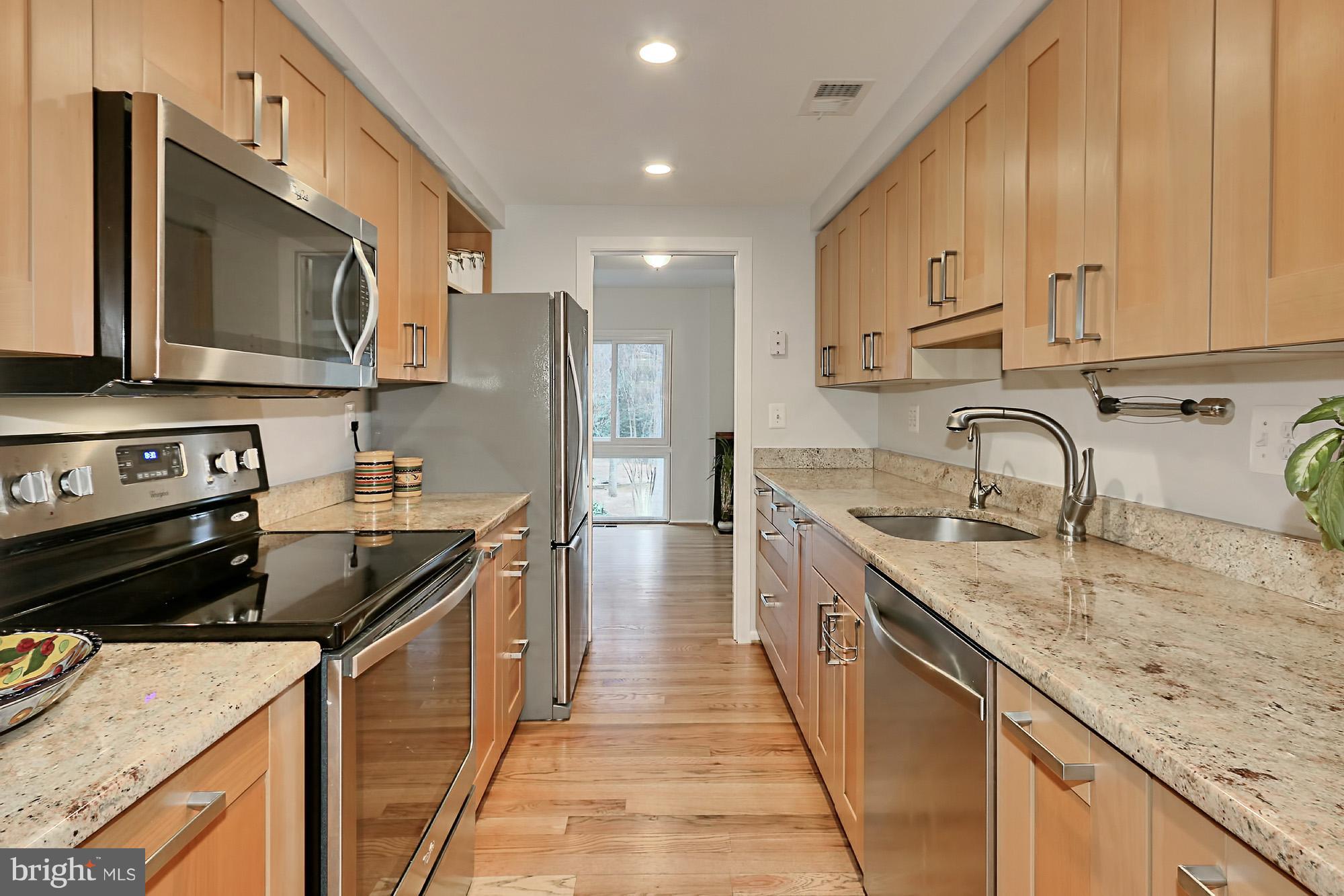 2380 Generation Drive Reston, VA 20191 - Photo 7 of 30 a kitchen with stainless steel appliances granite countertop a sink stove and refrigerator