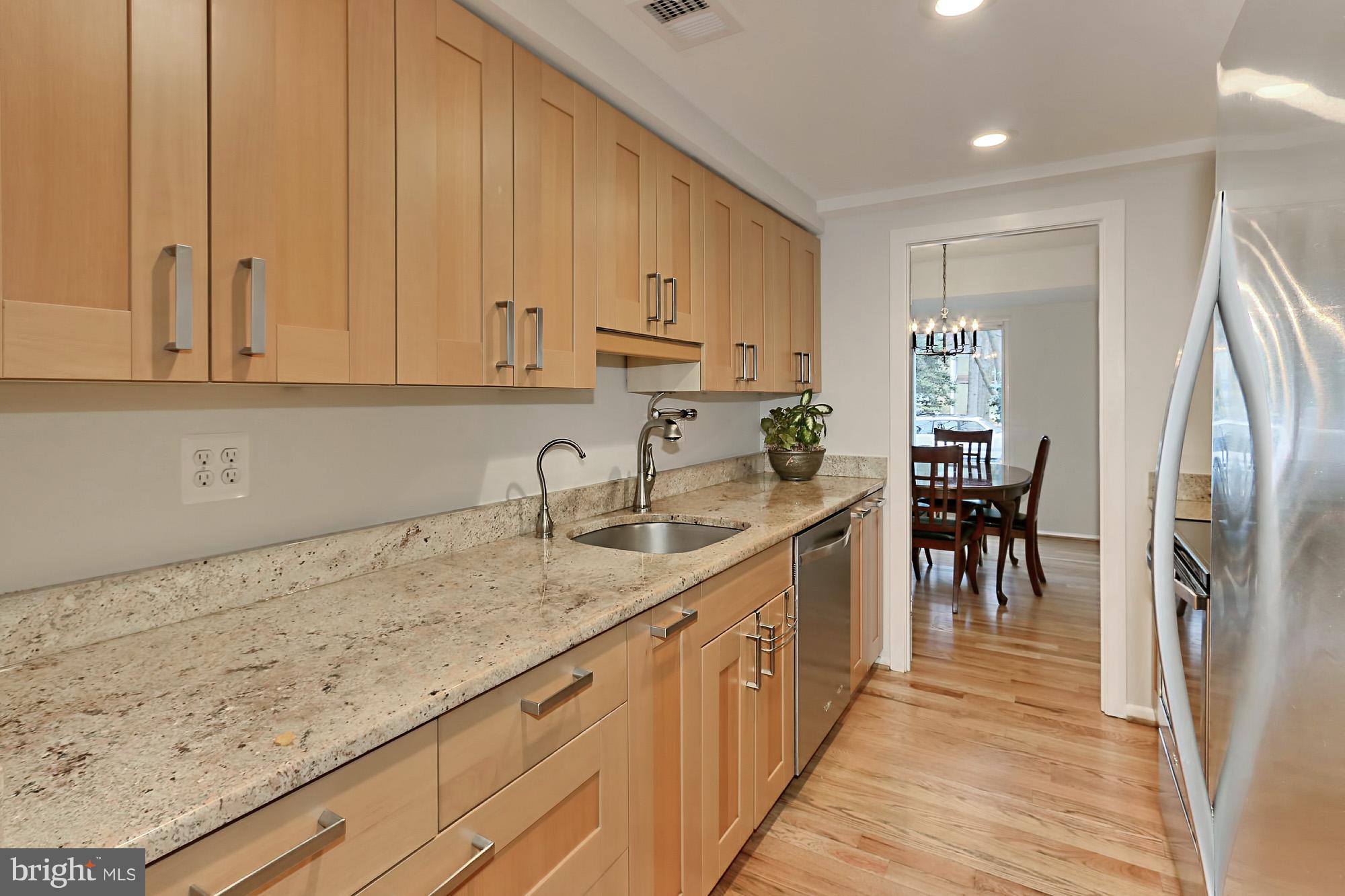 2380 Generation Drive Reston, VA 20191 - Photo 8 of 30 a kitchen with stainless steel appliances granite countertop a sink refrigerator and cabinets
