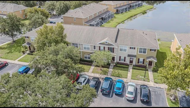 an aerial view of a house with swimming pool and outdoor seating