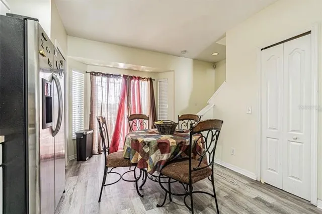 a dining room with furniture and a window
