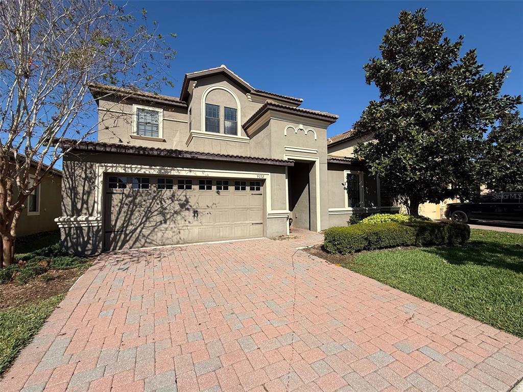 a front view of a house with a yard and garage