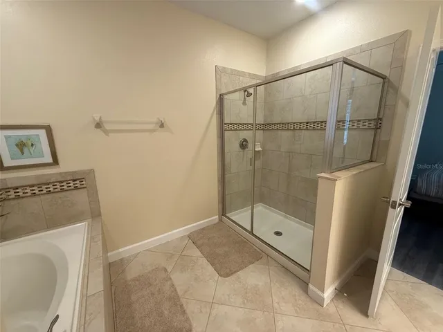 a bathroom with a shower and a sink