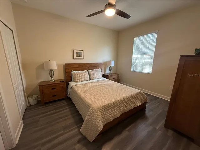 a bed sitting in a bedroom next to a window