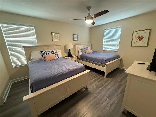 a bedroom with two beds and painting on the wall