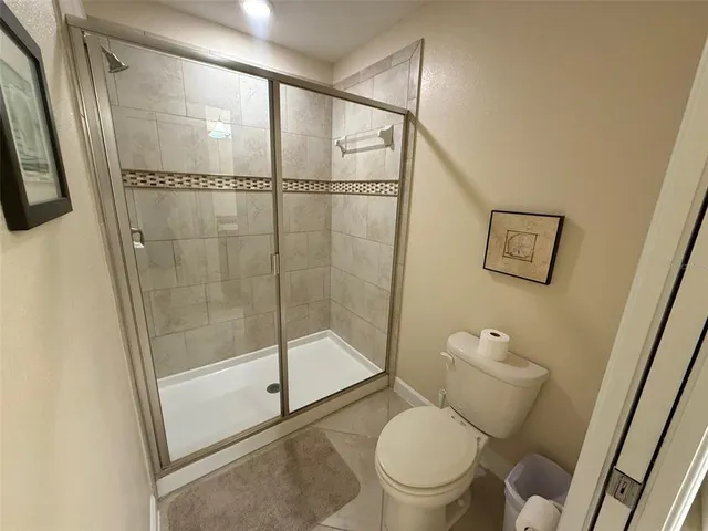 a bathroom with a toilet and a shower
