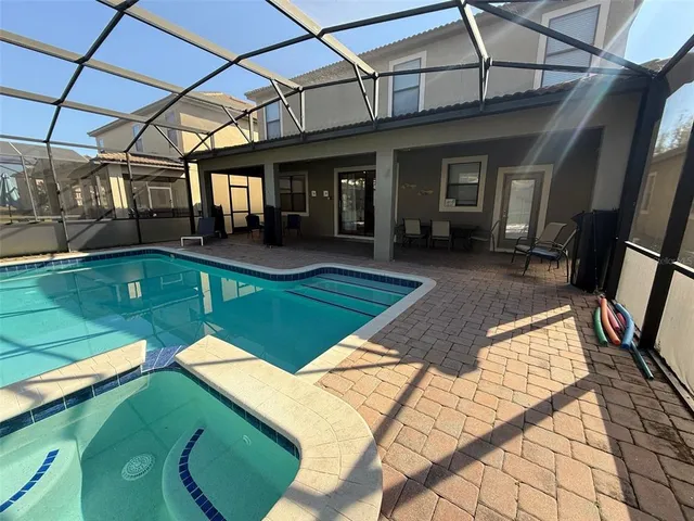 a view of a house with backyard porch and sitting area