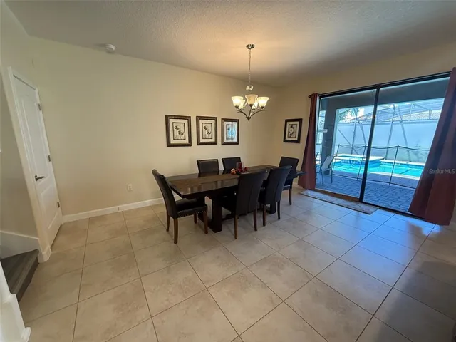 a view of a dining room with furniture and chandelier