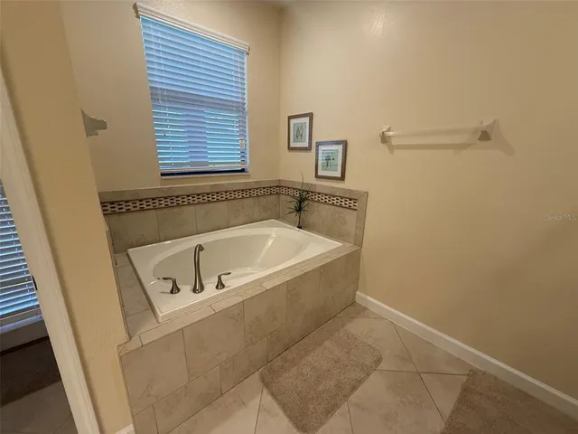 a white bath tub sitting next to a window