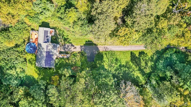 a view of a multi story yard with large trees