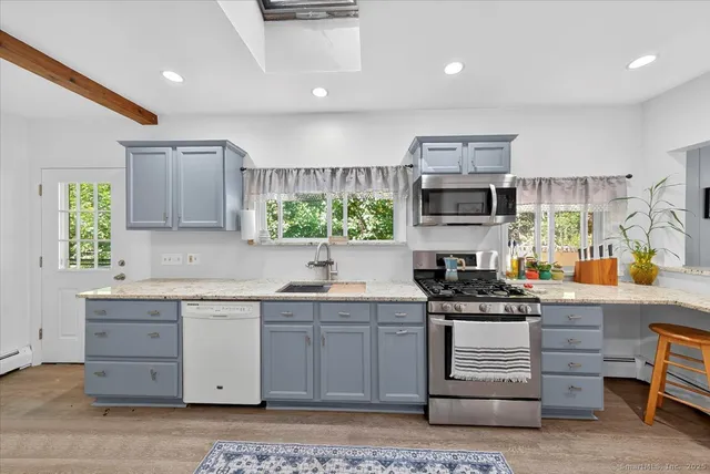 a kitchen with a sink stove and cabinets