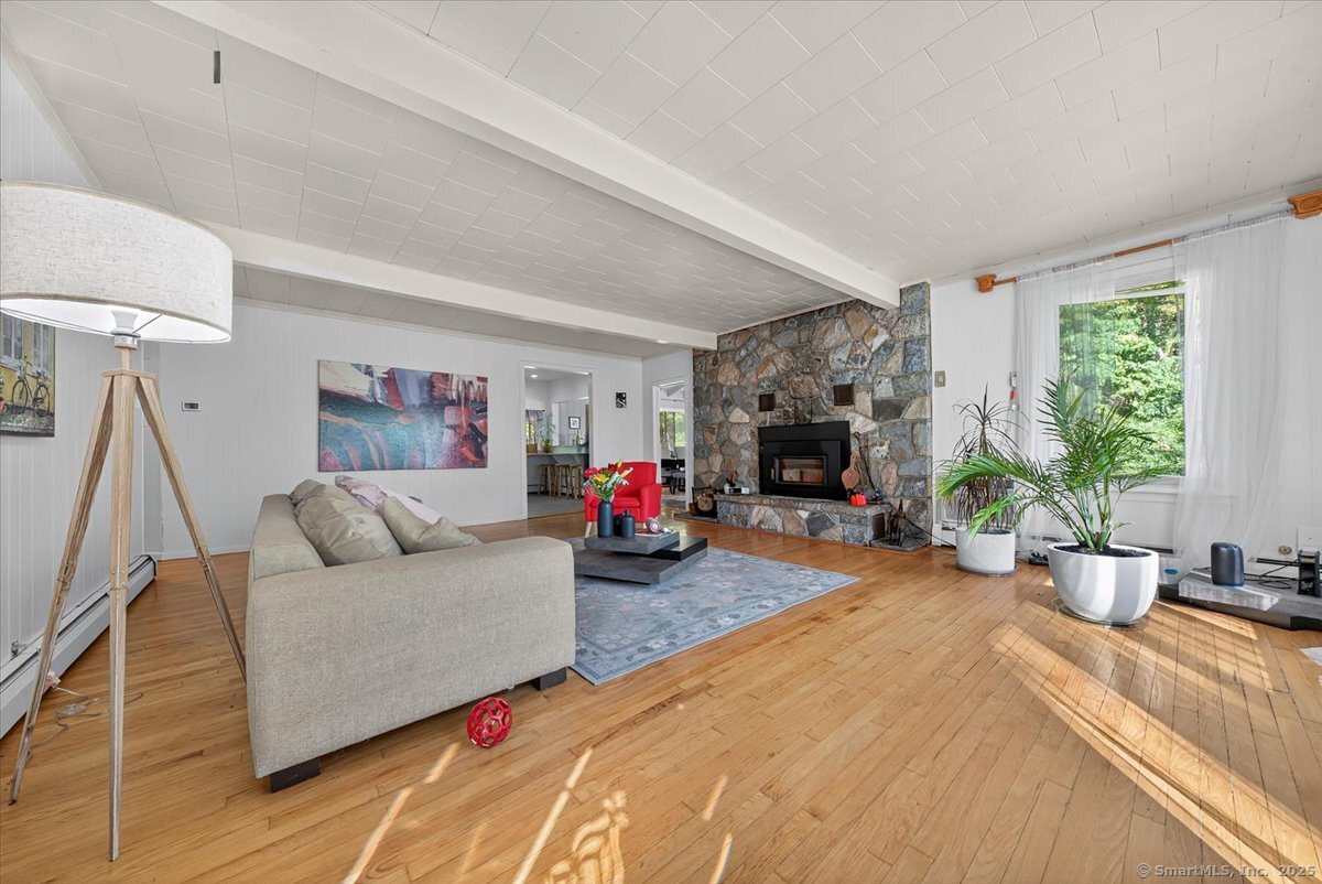153 Short Woods Road New Fairfield, CT 06812 - Photo 23 of 38 a living room with furniture and a fireplace