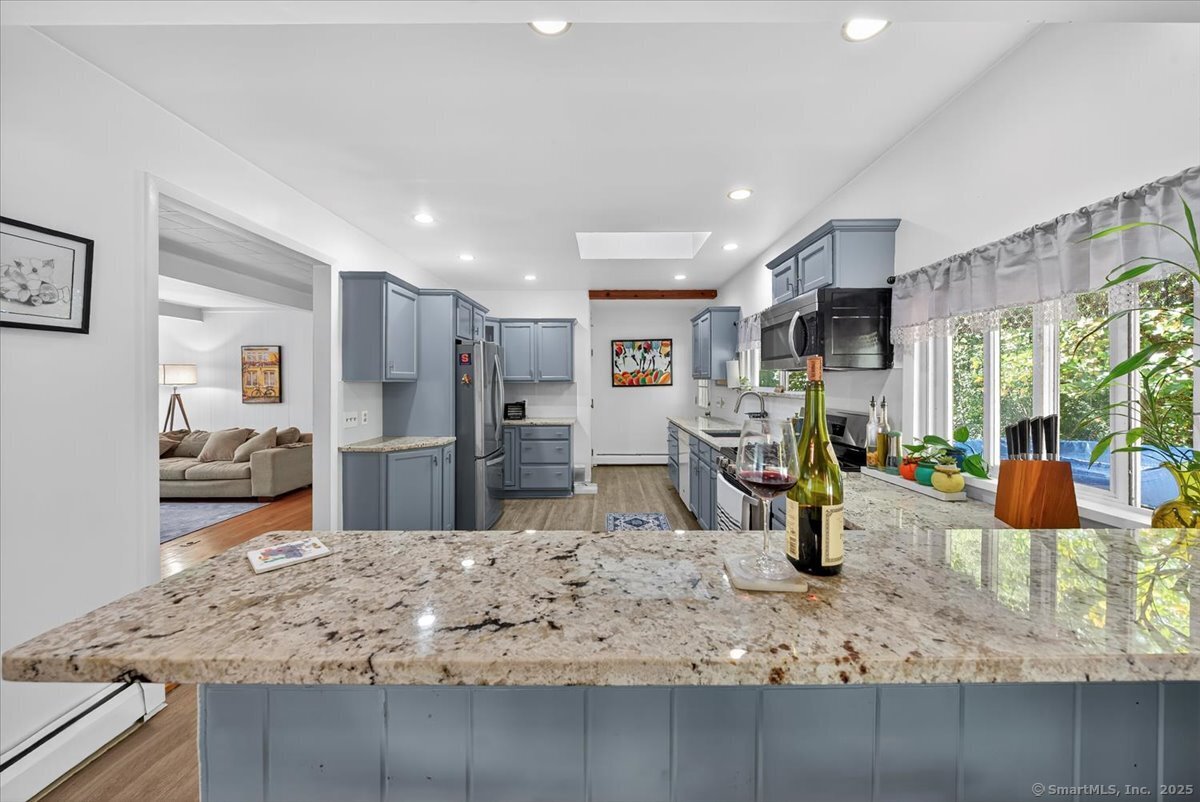 153 Short Woods Road New Fairfield, CT 06812 - Photo 29 of 38 a view of kitchen island sink and living room