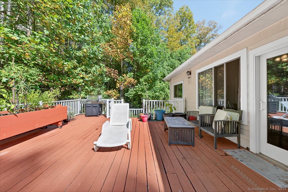 153 Short Woods Road New Fairfield, CT 06812 - Photo 31 of 38 a view of deck with table and chairs wooden floor and fence
