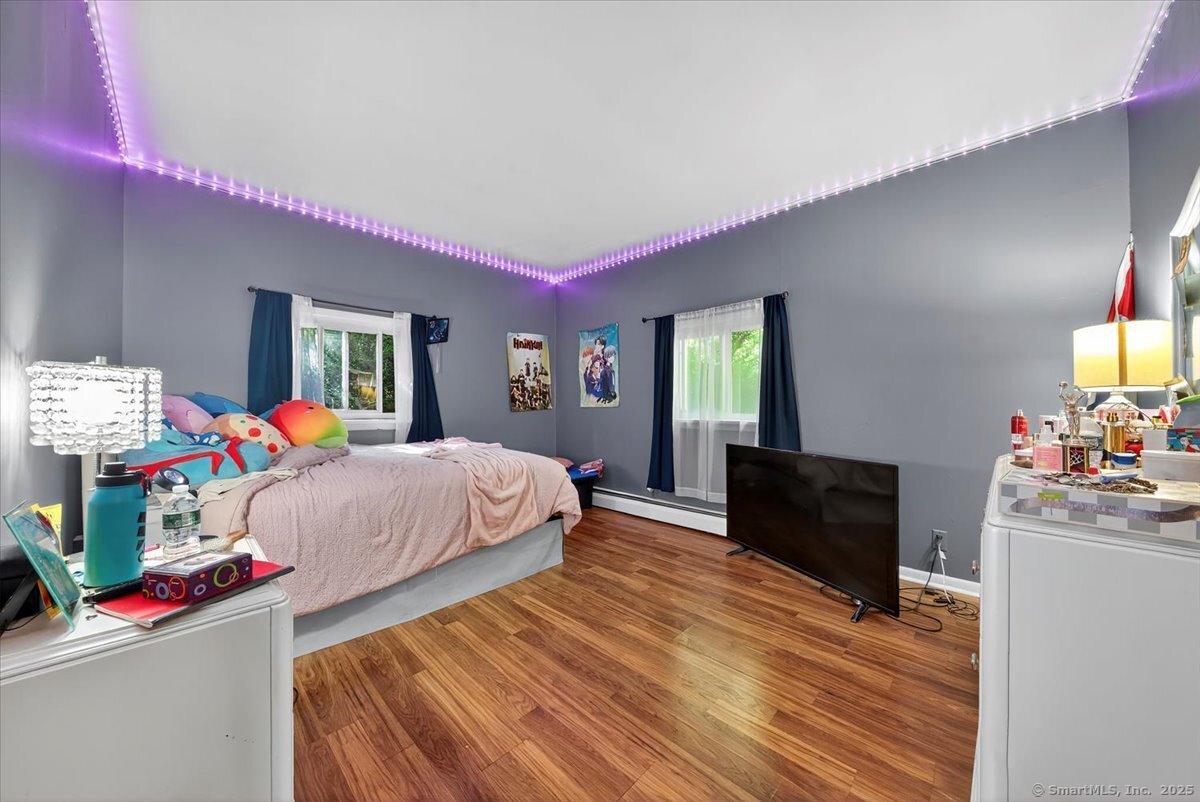 153 Short Woods Road New Fairfield, CT 06812 - Photo 5 of 38 a bed room with a bed window and potted plant