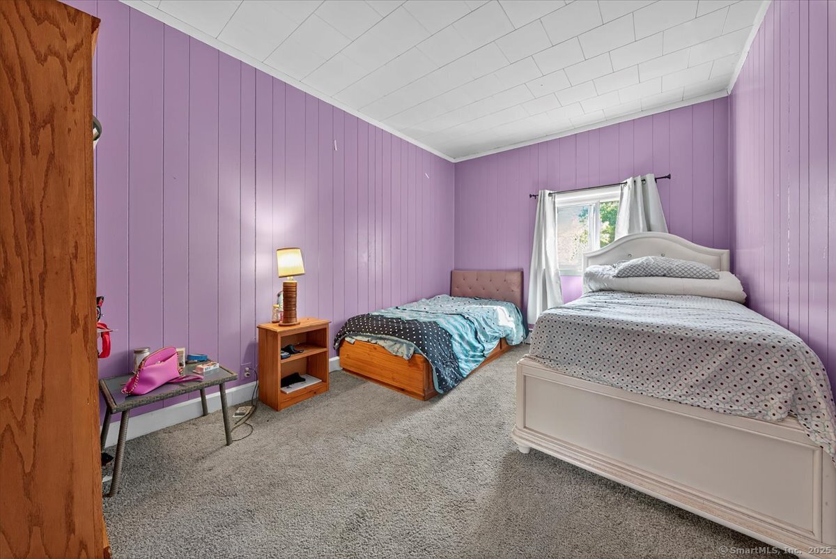 153 Short Woods Road New Fairfield, CT 06812 - Photo 7 of 38 a bedroom with a bed and a window