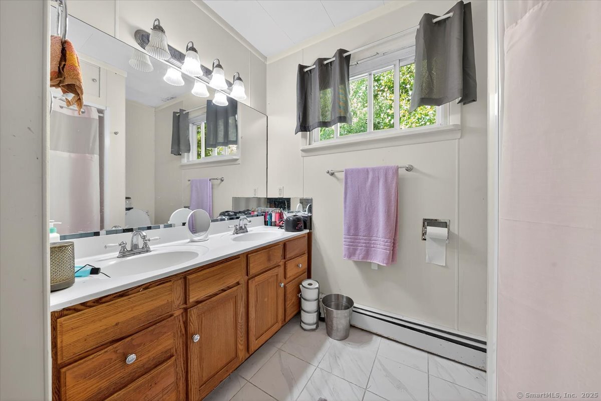 153 Short Woods Road New Fairfield, CT 06812 - Photo 8 of 38 a bathroom with a sink vanity and mirror
