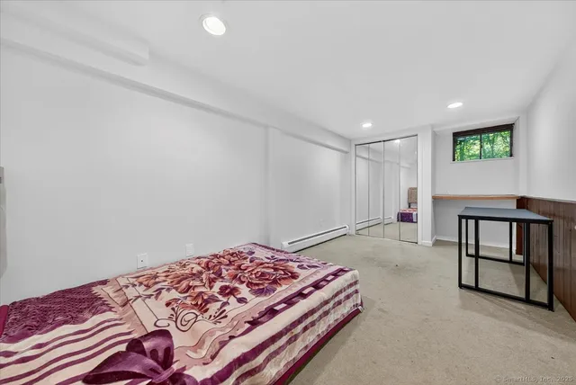 a bedroom with a bed and a desk