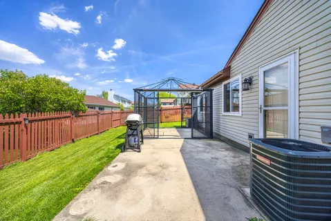 a view of a backyard with wooden fence