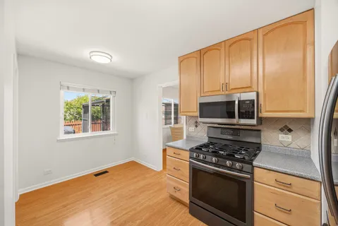 a kitchen with stainless steel appliances a stove a microwave and cabinets