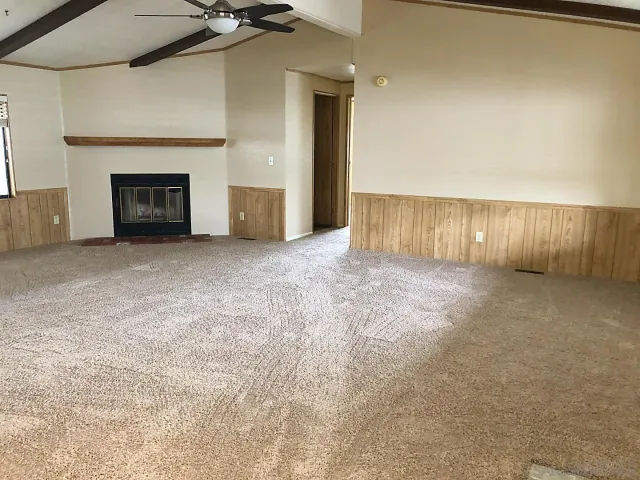 a view of an empty room with a fireplace