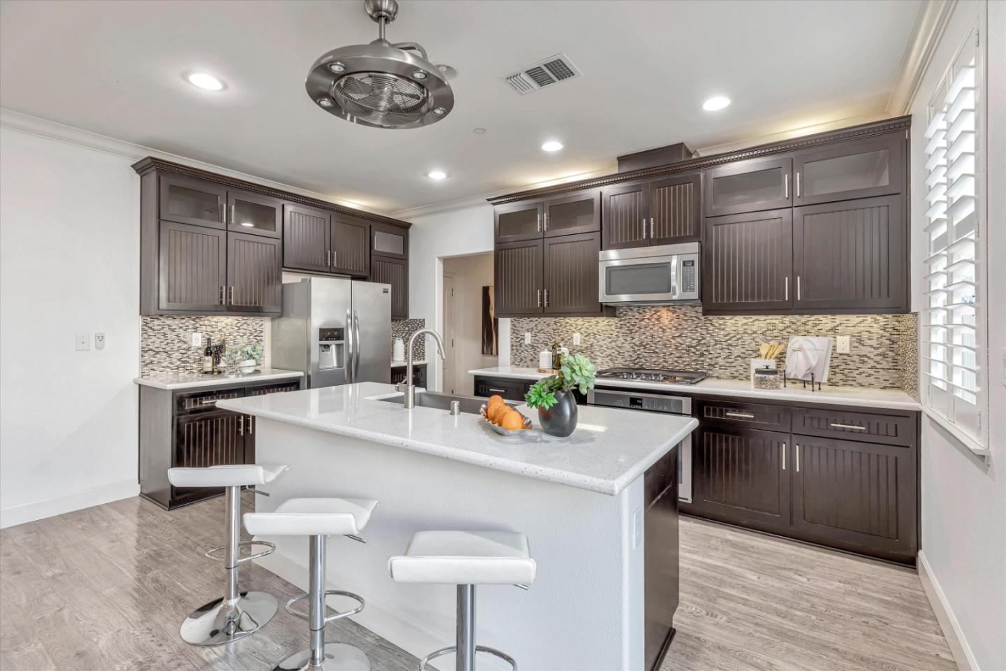 130 Palomino Place Gilroy, CA 95020 - Photo 14 of 50 a kitchen with stainless steel appliances granite countertop a sink refrigerator and cabinets