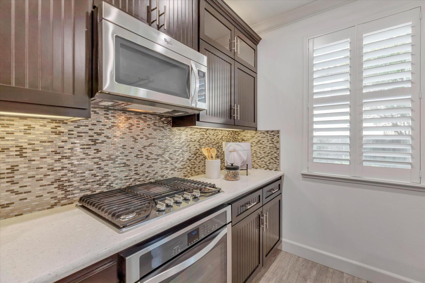 130 Palomino Place Gilroy, CA 95020 - Photo 16 of 50 a kitchen with granite countertop a stove sink and microwave