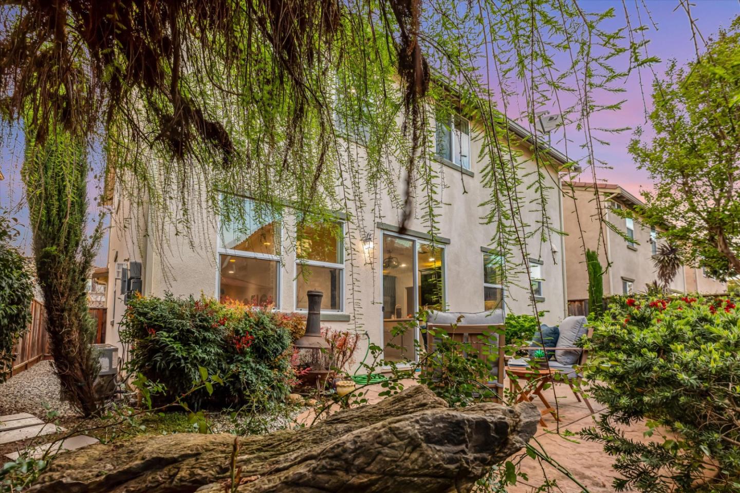 130 Palomino Place Gilroy, CA 95020 - Photo 45 of 50 a front view of a multi story residential apartment building with yard and green space