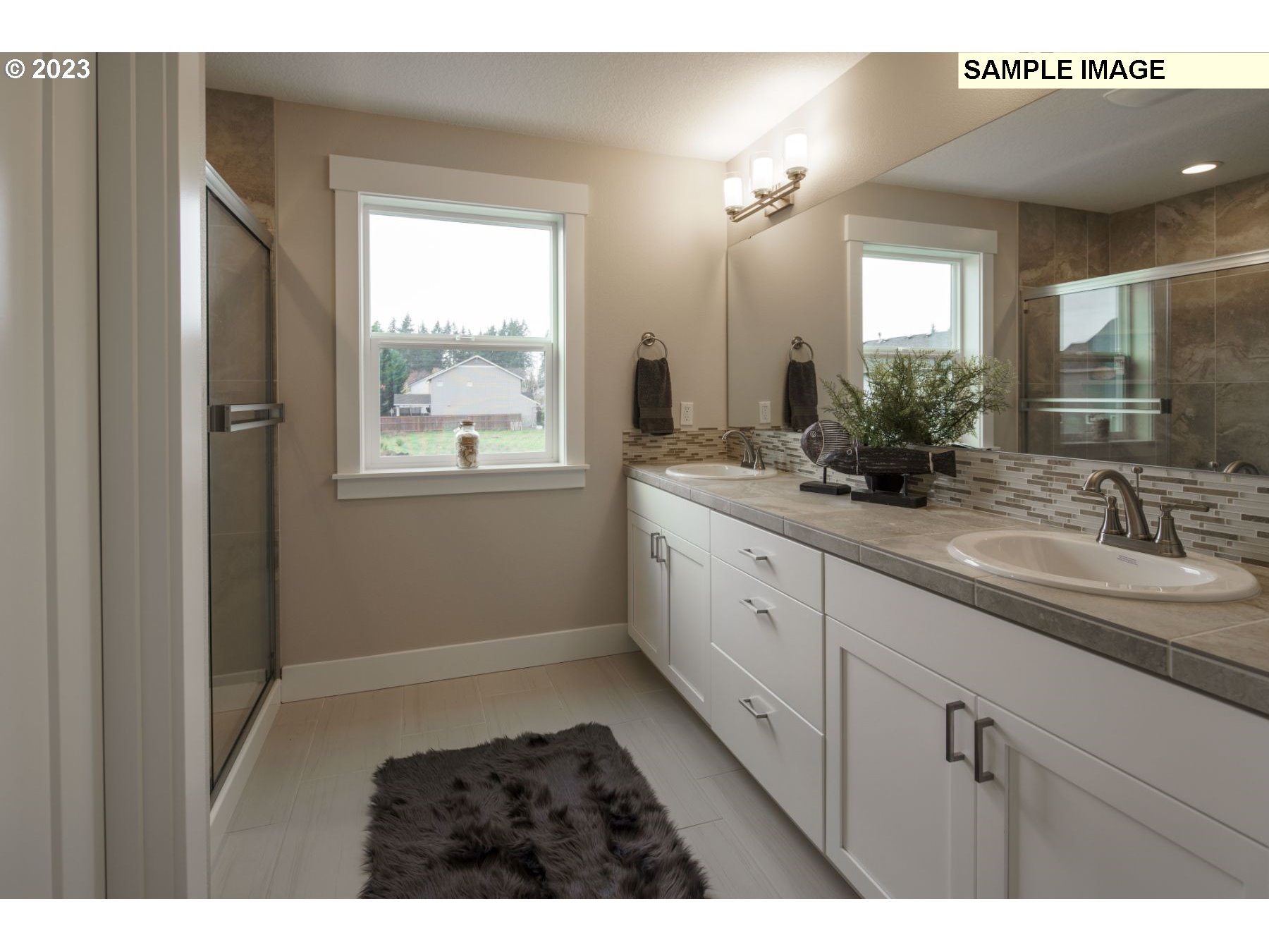 809 Northwest 178th Street Ridgefield, WA 98642 - Photo 19 of 25 a bathroom with a double vanity sink window and a mirror