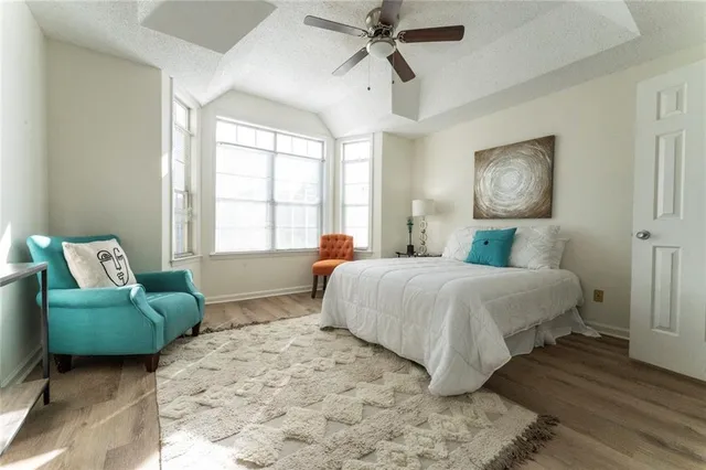 a bedroom with a bed couch and window