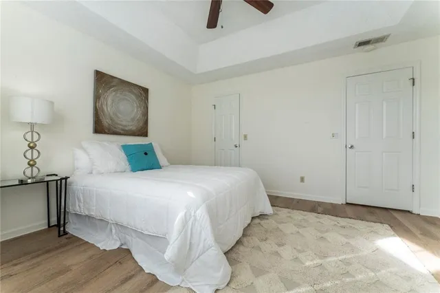 a bedroom with a bed and painting on the wall