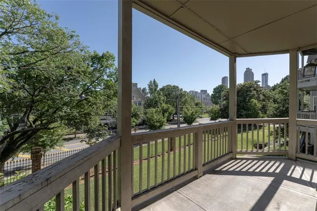 a view of a balcony with wooden floor