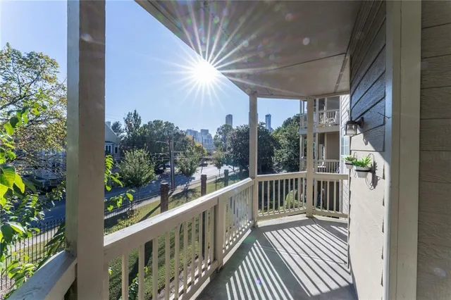 a view of a balcony with wooden floor