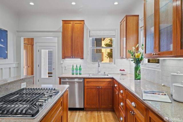 a kitchen with a sink stove and cabinets