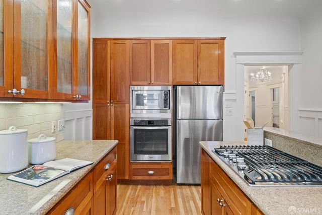 a kitchen with kitchen island a counter space a stove and a refrigerator