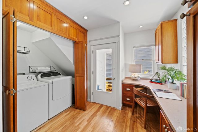 a bedroom with bed and a painting on the wall