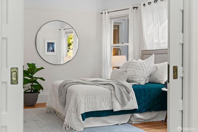 a bedroom with furniture and a wooden floor