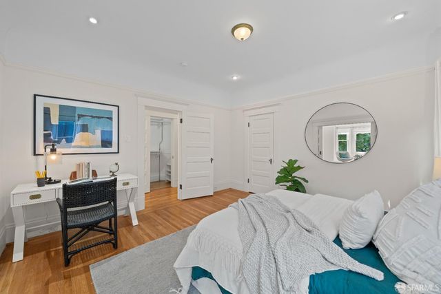 a bedroom with a bed and glass wall