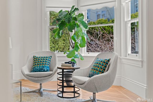 a living room with furniture and a potted plant