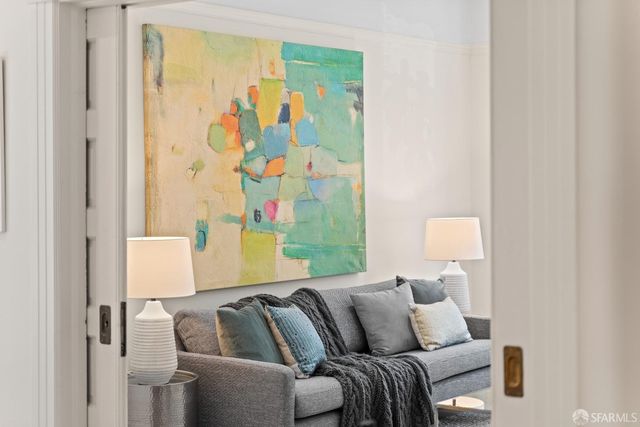 a living room with furniture and a blue wall