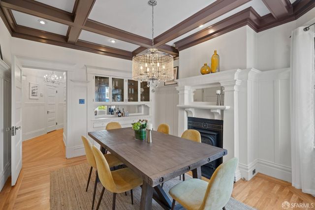 a view of a dining room with furniture and chandelier