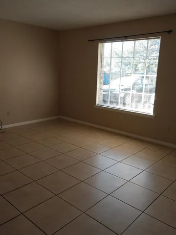 a view of an empty room and a window