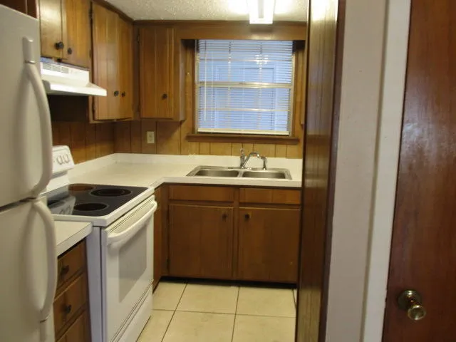 a kitchen with a sink cabinets and a window