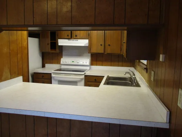 a kitchen with a stove and a refrigerator
