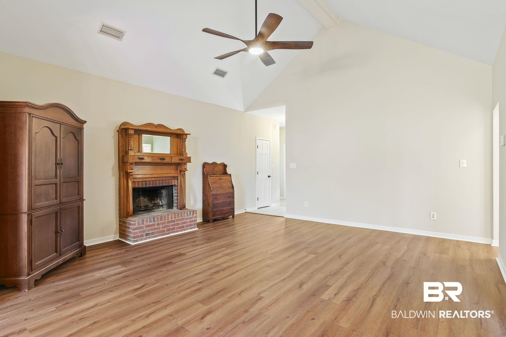 9631 Bay Meadows Avenue Fairhope, AL 36532 - Photo 11 of 49 Unfurnished living room with ceiling fan, beamed ceiling, high vaulted ceiling, light hardwood / wood-style floors, and a fireplace