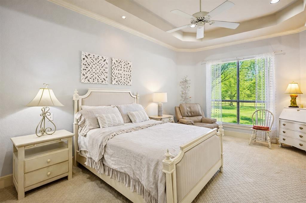 1520 Snider Court Lucas, TX 75002 - Photo 21 of 40 This second primary bedroom, or Mother-in-law suite, is on the first floor and has a large ensuite. Notice the tray ceiling and large window that offers lots of natural light and views of the lovely property.