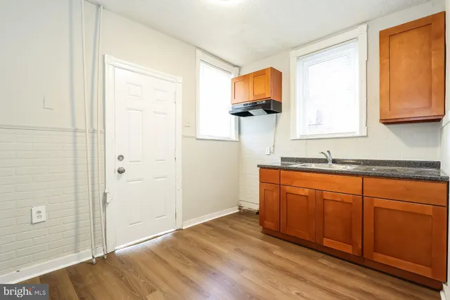 a spacious bathroom with a sink and a mirror